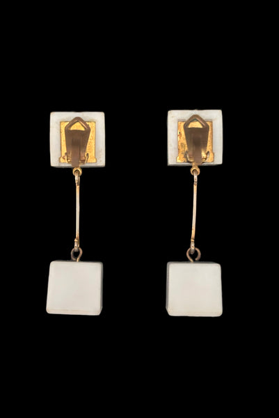 Vertical back view of 1960s vintage Mod gold tone and white Lucite cube bead top and drop clip-on dangle earrings.