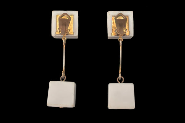 Horizontal back view of 1960s vintage Mod gold tone and white Lucite cube bead top and drop clip-on dangle earrings.
