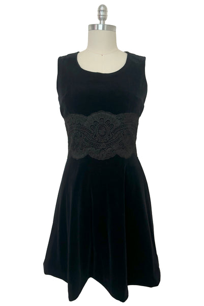 Front view of 1950s vintage black velveteen dress with scalloped lace midriff by Betty Barclay, medium to large.