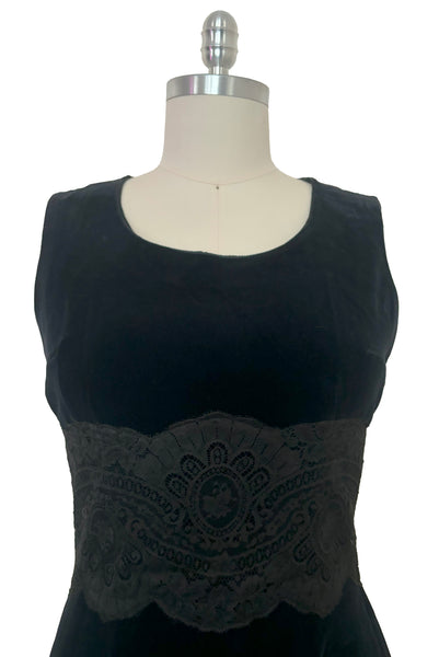 Bodice front view of 1950s vintage black velveteen dress with scalloped lace midriff by Betty Barclay, medium to large.