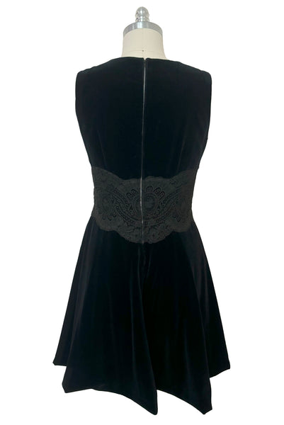 Back view of 1950s vintage black velveteen dress with scalloped lace midriff by Betty Barclay, medium to large.
