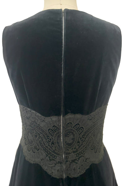 Bodice back view of 1950s vintage black velveteen dress with scalloped lace midriff by Betty Barclay, medium to large.