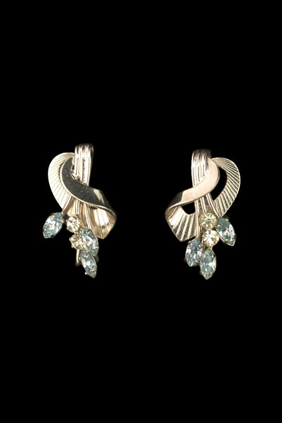Vertical front view of 1950s vintage blue marquise and round clear rhinestone floral sterling silver screw back earrings.