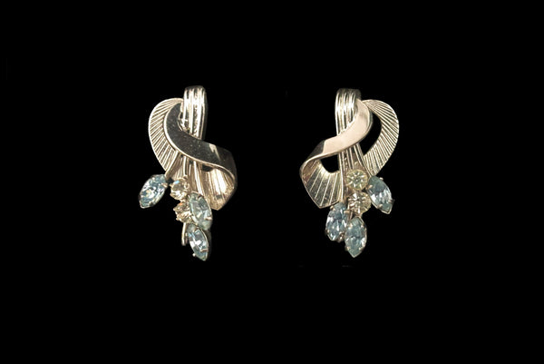 Horizontal front view of 1950s vintage blue marquise and round clear rhinestone floral sterling silver screw back earrings.