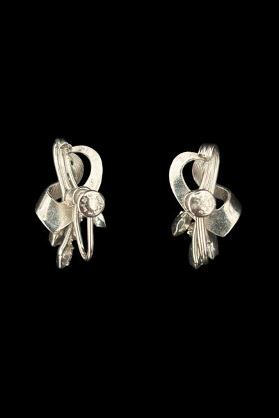 Vertical back view of 1950s vintage blue marquise and round clear rhinestone floral sterling silver screw back earrings.