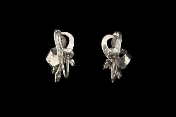 Horizontal back view of 1950s vintage blue marquise and round clear rhinestone floral sterling silver screw back earrings.