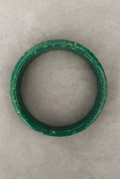 Vertical top view of 1960s vintage green and white mottled textured two (2) sliced bangle bracelet set. Showing a single bangle.