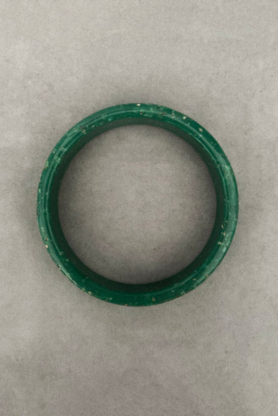 Vertical top view of 1960s vintage green and white mottled textured two (2) sliced bangle bracelet set. Showing a single bangle.
