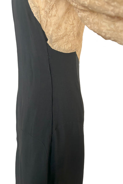 Detail view of 1930s vintage cream lace sheer back Juliet sleeve square neck black crepe midi dress, size extra small to small. Showing the side placket with tuck taken to hide some damage.