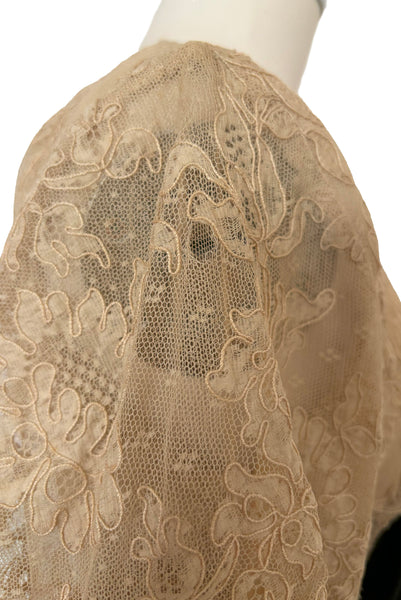 Detail view of 1930s vintage cream lace sheer back Juliet sleeve square neck black crepe midi dress, size extra small to small. Showing a small hole in the puff of one of the lace Juliet sleeves.