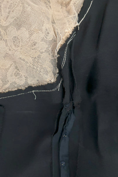 Detail view of 1930s vintage cream lace sheer back Juliet sleeve square neck black crepe midi dress, size extra small to small. Showing the interior of the side snap placket with a tuck taken to hide some damage to the black crepe.