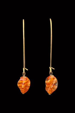 Vertical front view of 2010s vintage marbled orange glass lampwork beads on long gold tone earwire drop earrings.
