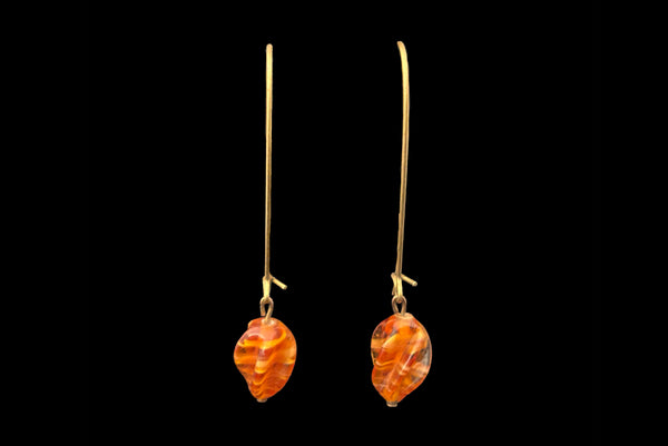 Horizontal front view of 2010s vintage marbled orange glass lampwork beads on long gold tone earwire drop earrings.