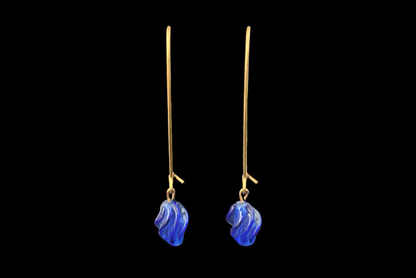Horizontal front view of 2010s blue glass lampwork beads on long gold tone earwires pierced drop earrings. Made from vintage components.