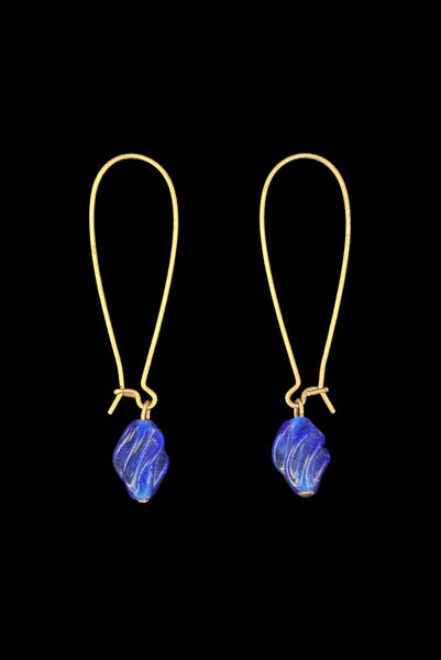 Vertical side view of 2010s blue glass lampwork beads on long gold tone earwires pierced drop earrings. Made from vintage components.