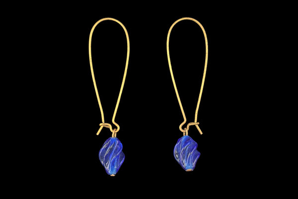 Horizontal side view of 2010s blue glass lampwork beads on long gold tone earwires pierced drop earrings. Made from vintage components.