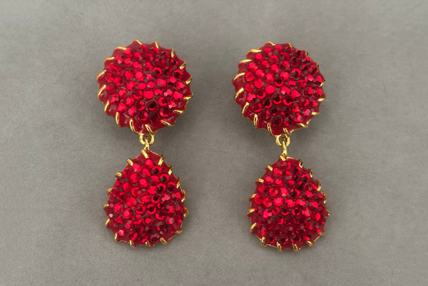 Horizontal front view of 1990s vintage red rhinestone & enamel, gold tone top and drop clip-on statement earrings.