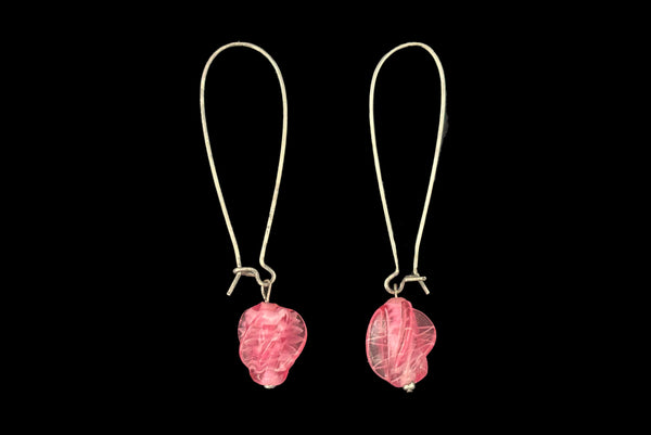 Horizontal side view of 2010s pink glass lampwork bead on long silver tone earwire pierced drop earrings. Made from vintage components.