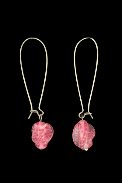 Vertical side view of 2010s pink glass lampwork bead on long silver tone earwire pierced drop earrings. Made from vintage components.