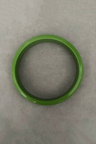 Vertical bottom view of 1980s vintage leaf green two (2) domed, and one (1) saucer three (3) bangle bracelet set. Showing one domed bangle.