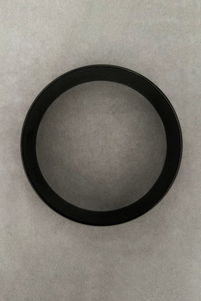 Vertical top view of 1980s vintage black plastic twisted, ridged, and orange goldfish painted bangle bracelet set of three (3). Showing the goldfish painted bangle only.