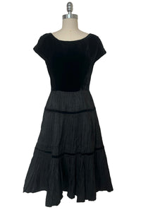 Front view of 1950s vintage black velvet and crinkled taffeta dress, by R&K Originals, size extra small to small.