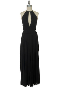 Front view of vintage new with tags 1970s split front black jersey evening dress by Roter Couture, medium to large. Showing the revealing split halter neckline, and draped skirt.