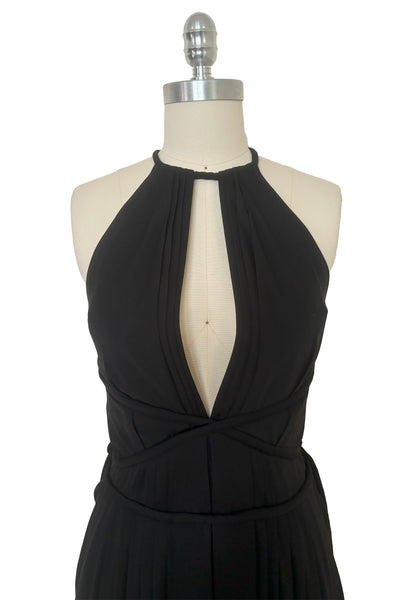 Bodice front view of vintage new with tags 1970s split front black jersey evening dress by Roter Couture, medium to large. Showing the revealing split halter neckline, and ties wrapping the waist.