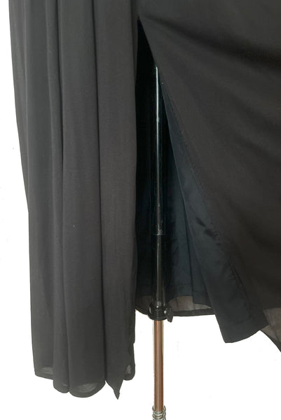 Skirt detail view of vintage new with tags 1970s split front black jersey evening dress by Roter Couture, medium to large. Showing the narrower lining inside the draped skirt.