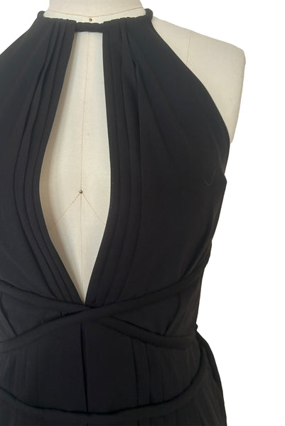 Bodice front view of vintage new with tags 1970s split front black jersey evening dress by Roter Couture, medium to large. Showing the revealing split halter neckline, and ties wrapping the waist.