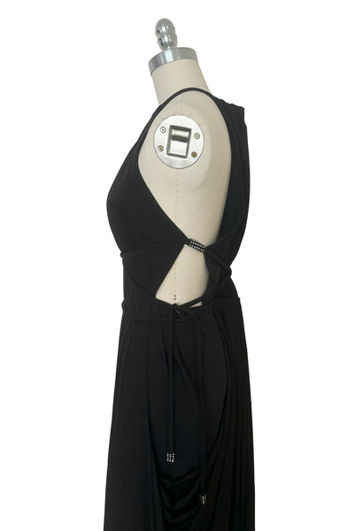 Side bodice view of vintage new with tags 1970s split front black jersey evening dress by Roter Couture, medium to large. Showing the revealing halter neckline, and open sides.