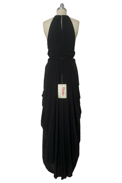 Back view of vintage new with tags 1970s split front black jersey evening dress by Roter Couture, medium to large. Showing High split back and draped skirt.