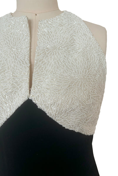 Bodice detail view of 1990s vintage cream beaded satin halter neck & black velvet evening dress by Carmen Marc Valvo, extra small to small. Showing the densely beaded top of cream glass seed and cut beads.