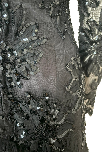 Back detail view of 1980s vintage black satin, sequin lace, & dotted tulle asymmetrical cocktail dress by Mignon, small to medium. New with tags. Showing the floral lace embellished with sequins at the back hip.