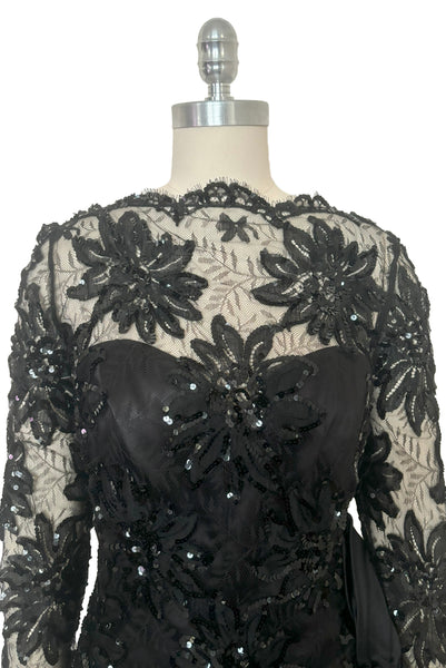 Bodice front view of 1980s vintage black satin, sequin lace, & dotted tulle asymmetrical cocktail dress by Mignon, small to medium. New with tags. Showing the sweetheart strapless satin underlay and the floral lace & sequin straight neck overlay.