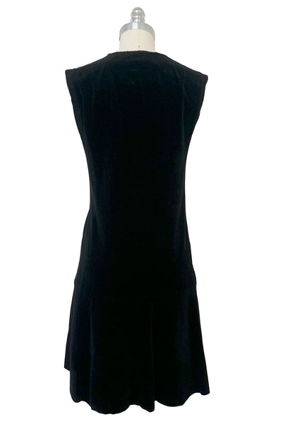 Back view of 1960s vintage black velveteen rhinestone button front drop waist jumper dress, small to medium.