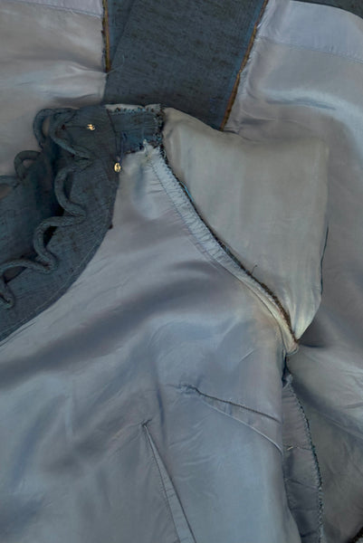 Interior detail view of 1950s vintage sapphire blue and black raw silk scalloped scoop neck, short sleeve, pencil skirt cocktail dress, size small to medium. Showing the neckline facing, lining fabric, and light discoloration at the under arms.