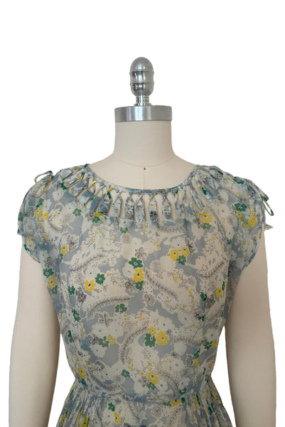 Bodice front view of 1940s sheer blue nylon green and yellow floral & spiderweb novelty print dress, small to medium.