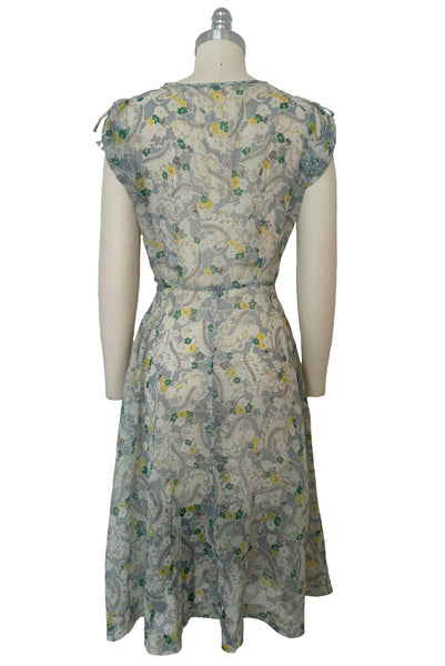 Back view of 1940s sheer blue nylon green and yellow floral & spiderweb novelty print dress, small to medium.