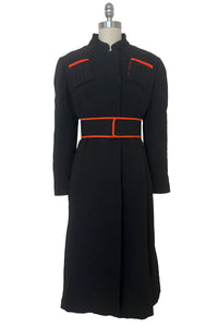 Belted front view of 1970s vintage midi length black and orange wool coat with belt, by Gloria Sachs, size small to medium.