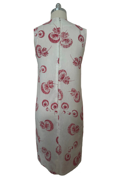 Back view of 1960s vintage crew neck sleeveless white shantung sheath dress with red dandelion novelty floral print, size small to medium.