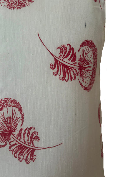 Detail view of 1960s vintage crew neck sleeveless white shantung sheath dress with red dandelion novelty floral print, size small to medium. Showing a dark spot in the slubbed fabric.