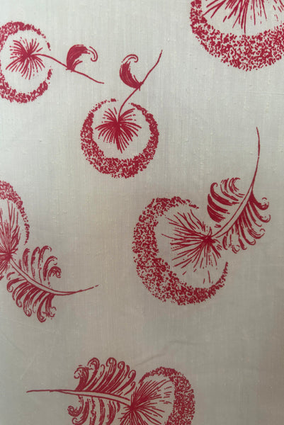 Detail view of 1960s vintage crew neck sleeveless white shantung sheath dress with red dandelion novelty floral print, size small to medium. Showing a a close up of the stylized flower print.