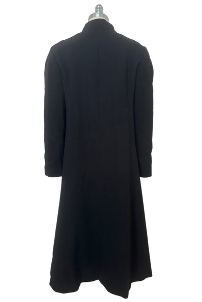 Back view of 1970s vintage midi length black and orange wool coat with belt, by Gloria Sachs, size small to medium.