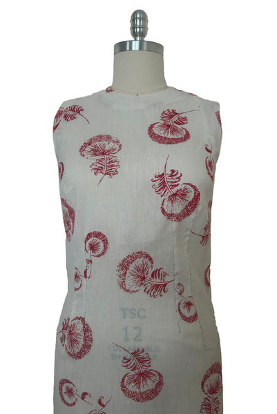 Bodice front view of 1960s vintage crew neck sleeveless white shantung sheath dress with red dandelion novelty floral print, size small to medium.