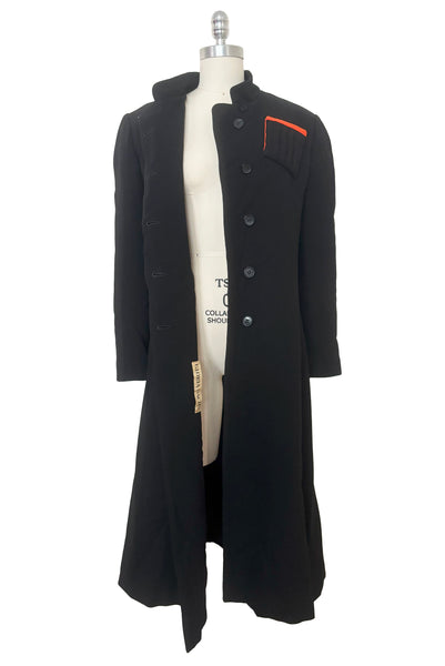 Open front view of 1970s vintage midi length black and orange wool coat with belt, by Gloria Sachs, size small to medium. Showing the black plastic buttons. 