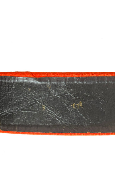 Belt detail view of 1970s vintage midi length black and orange wool coat with belt, by Gloria Sachs, size small to medium. Showing some damage to the backing on the belt.