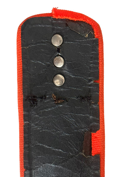 Belt detail view of 1970s vintage midi length black and orange wool coat with belt, by Gloria Sachs, size small to medium. Showing some damage to the backing on the belt.