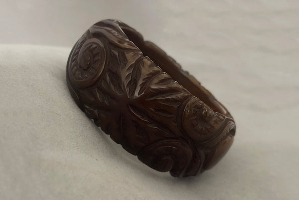 Horizontal perspective view of 1930s vintage novelty octopus sea life carved green Bakelite statement bangle bracelet.