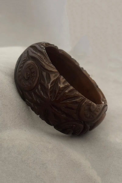 Vertical perspective view of 1930s vintage novelty octopus sea life carved green Bakelite statement bangle bracelet.